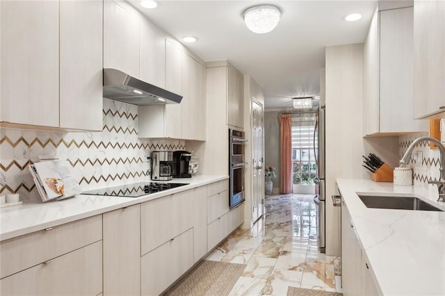 641 Petit Berdot Dr, Kenner, LA 70065 - kitchen with under cabinet range hood, a sink, light marble finish floors, double oven, and tasteful backsplash