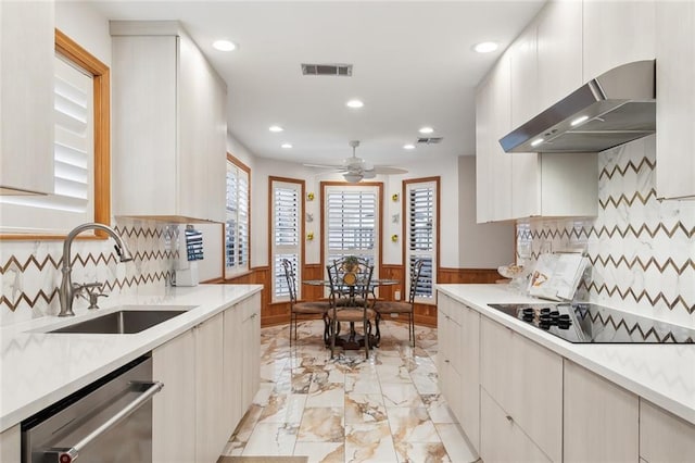 641 Petit Berdot Dr, Kenner, LA 70065 - kitchen featuring extractor fan, dishwasher, a sink, black electric cooktop, and wainscoting