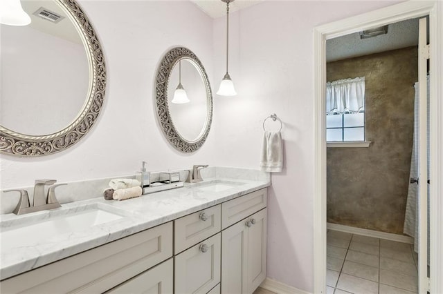 641 Petit Berdot Dr, Kenner, LA 70065 - bathroom with double vanity, tile patterned flooring, and baseboards