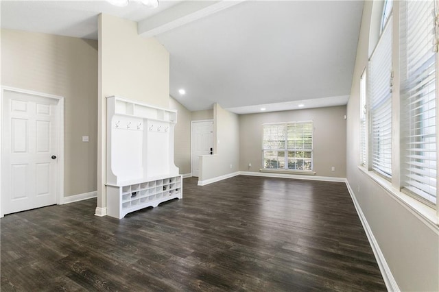 unfurnished living room with beam ceiling, high vaulted ceiling, baseboards, and wood finished floors