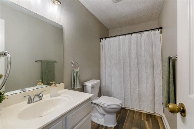 bathroom with toilet, a textured ceiling, wood finished floors, a shower with shower curtain, and vanity