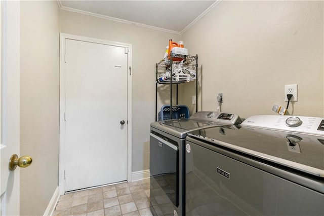 laundry room featuring baseboards, ornamental molding, laundry area, and washer and clothes dryer