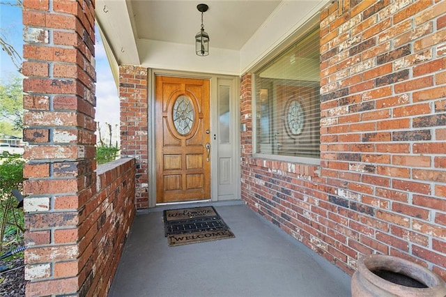 doorway to property with brick siding