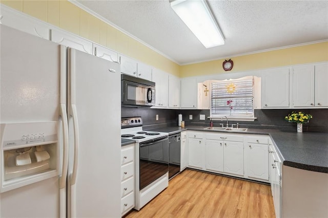 kitchen with black microwave, a sink, electric stove, white fridge with ice dispenser, and dark countertops