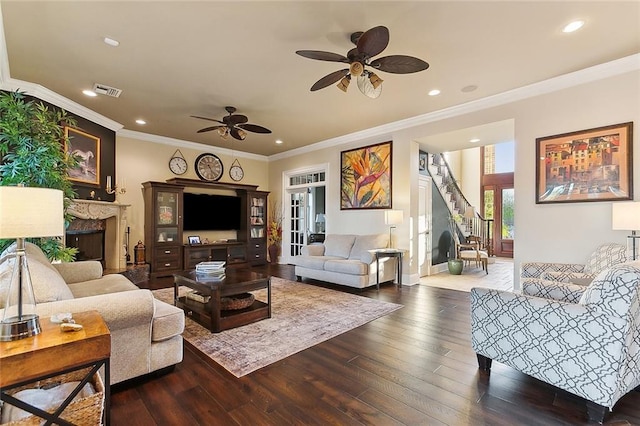 living room with a premium fireplace, stairway, hardwood / wood-style floors, crown molding, and recessed lighting