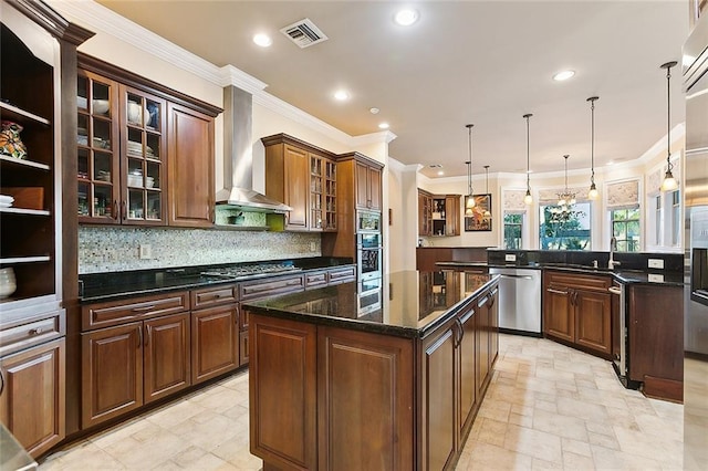 kitchen with gas stovetop, visible vents, a large island, stainless steel dishwasher, and wall chimney exhaust hood