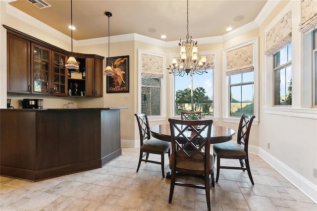 dining room featuring baseboards, crown molding, visible vents, and a healthy amount of sunlight