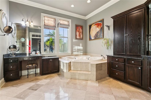 full bath featuring a garden tub, ornamental molding, and vanity