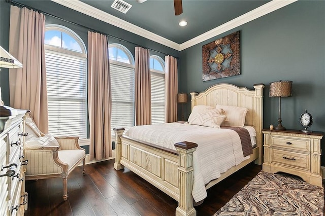 bedroom with ceiling fan, dark wood finished floors, visible vents, and crown molding