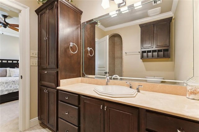 ensuite bathroom with ceiling fan, vanity, ornamental molding, and ensuite bathroom