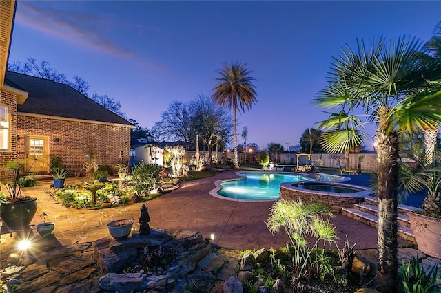 view of swimming pool featuring a fenced backyard, a fenced in pool, a patio, and an in ground hot tub