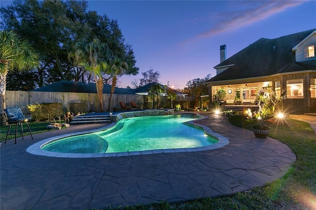 view of swimming pool with a patio area, a fenced backyard, and a pool with connected hot tub