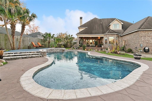 view of swimming pool featuring a fenced in pool, a fenced backyard, and a patio