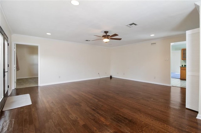 spare room with baseboards, ceiling fan, dark wood-style flooring, and crown molding