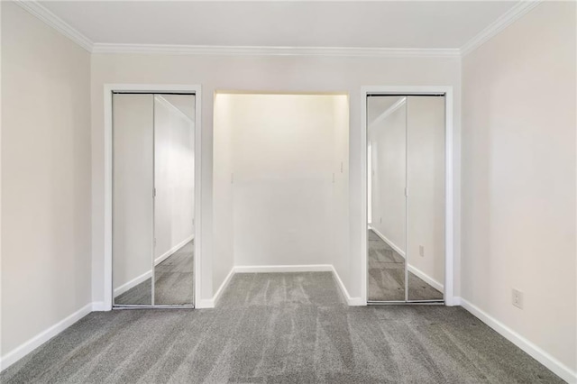 unfurnished bedroom with carpet, two closets, and crown molding