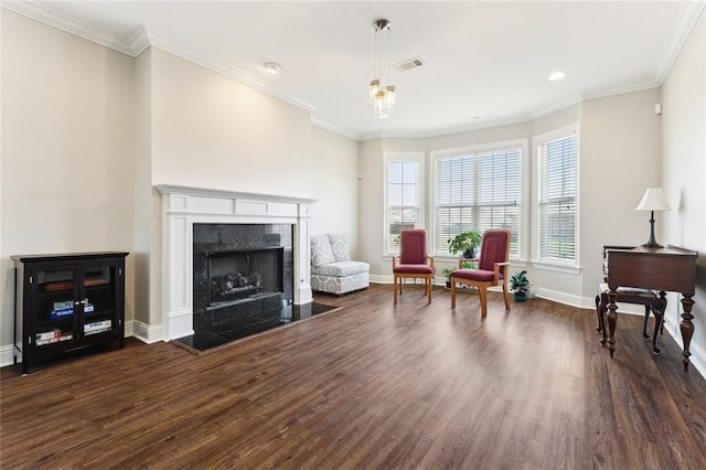 sitting room featuring ornamental molding, dark wood finished floors, and a high end fireplace