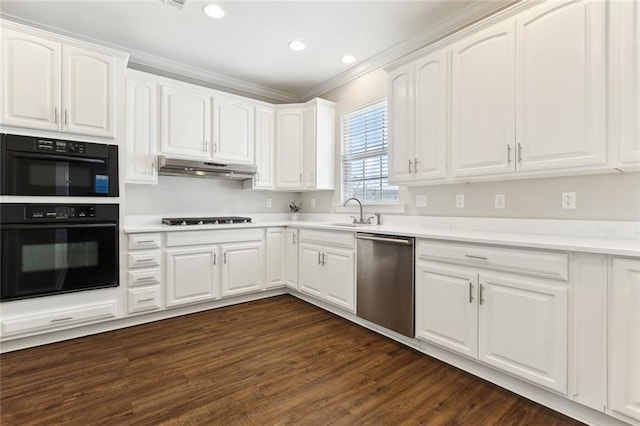 kitchen with dark wood-style floors, white cabinets, stovetop, under cabinet range hood, and dishwasher