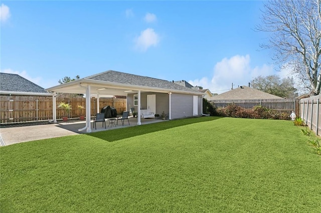 back of house featuring a fenced backyard, a patio, and a lawn