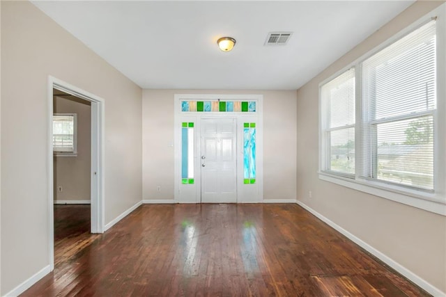 foyer with a healthy amount of sunlight, visible vents, and hardwood / wood-style floors