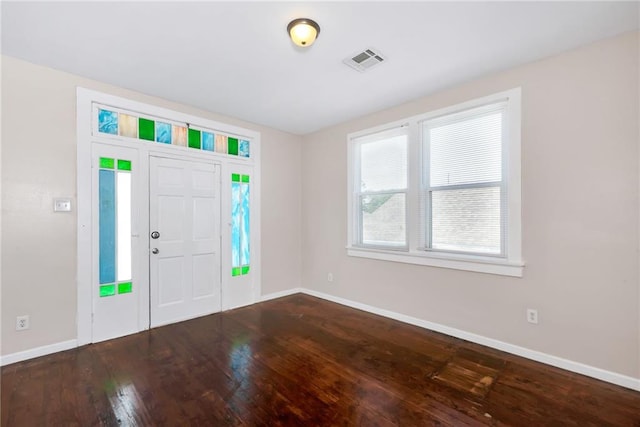 foyer with wood-type flooring, visible vents, and baseboards