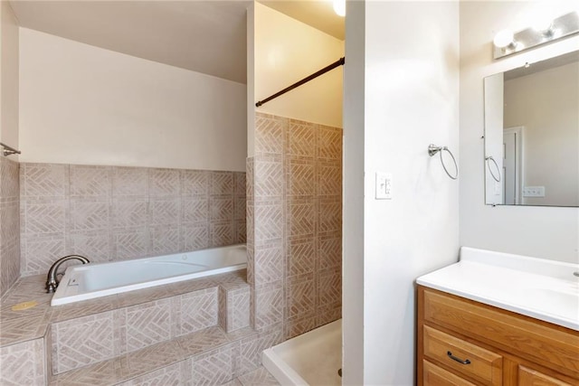 full bath featuring a garden tub, a tile shower, and vanity