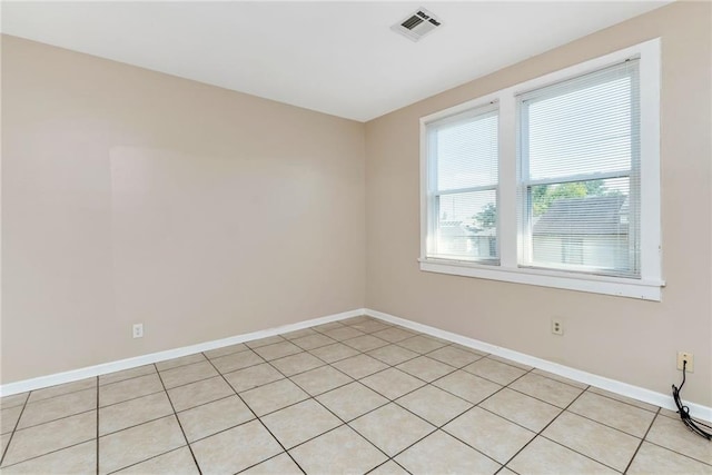 spare room featuring visible vents and baseboards