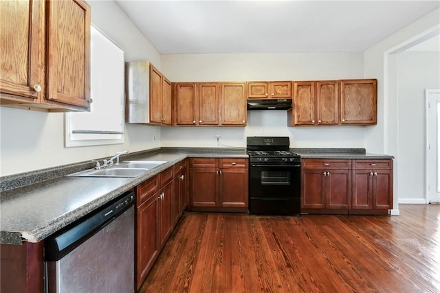 kitchen with black range with gas cooktop, under cabinet range hood, dark wood-style flooring, a sink, and stainless steel dishwasher