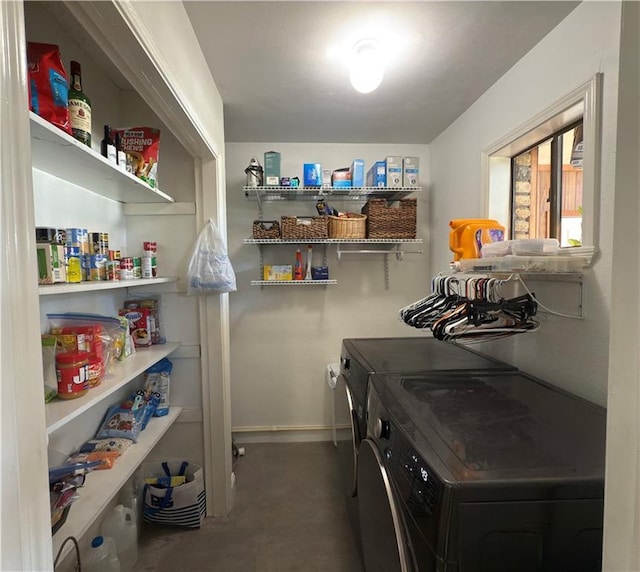 laundry area with separate washer and dryer, laundry area, and baseboards
