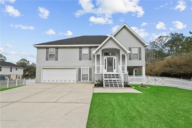 bi-level home featuring a front yard, concrete driveway, fence, and an attached garage