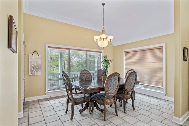 dining space with ornamental molding, a notable chandelier, and baseboards