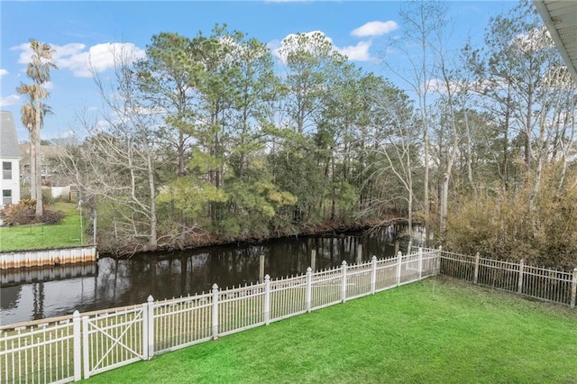 view of yard featuring a water view and fence