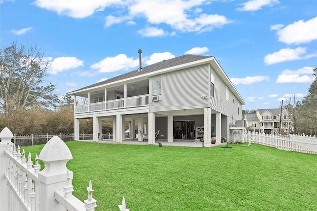 rear view of house featuring a yard, a patio area, a balcony, cooling unit, and a fenced backyard