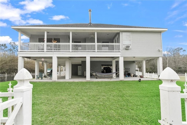 back of house with a carport, a yard, a patio area, and a balcony