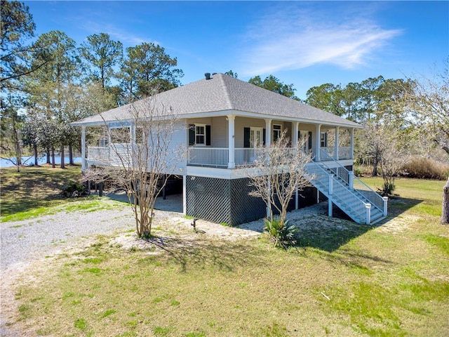 back of house with a shingled roof, stairway, a porch, and a yard