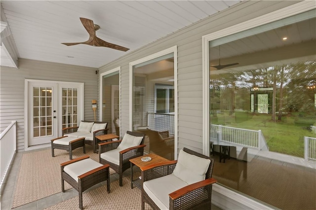 sunroom featuring ceiling fan and french doors