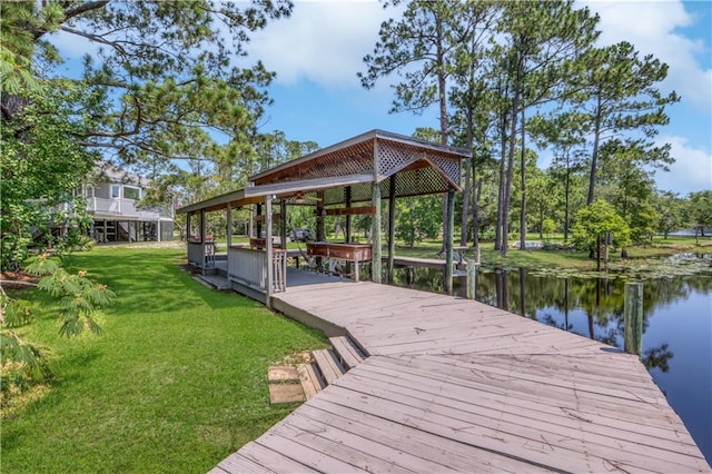 dock area with a water view and a yard