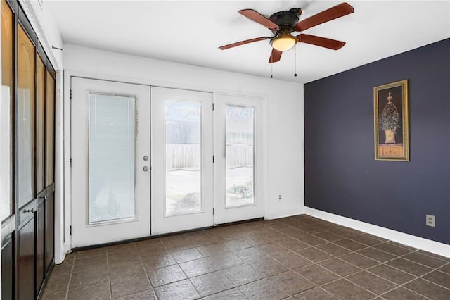 entryway with french doors, a ceiling fan, and baseboards