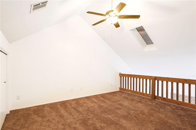 bonus room with visible vents, vaulted ceiling with skylight, carpet, and a ceiling fan