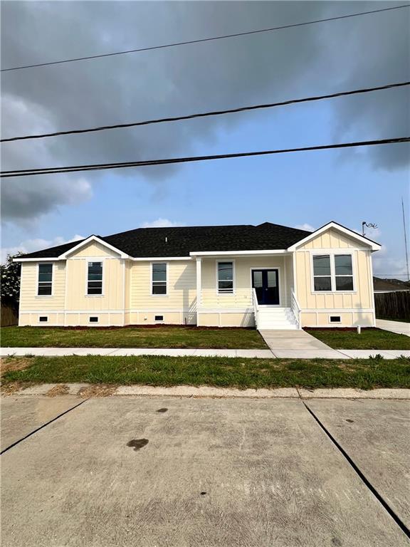 view of front of property with crawl space, entry steps, a front lawn, and roof with shingles