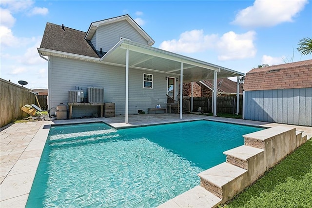 view of pool with a storage unit, an outdoor structure, a fenced backyard, and a fenced in pool