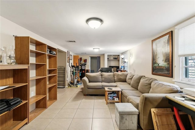 living room featuring light tile patterned floors and visible vents