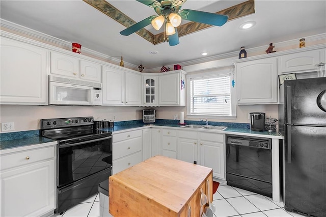 kitchen featuring light tile patterned floors, glass insert cabinets, white cabinetry, a sink, and black appliances