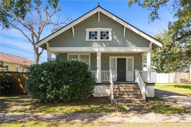 bungalow-style home featuring fence and a porch