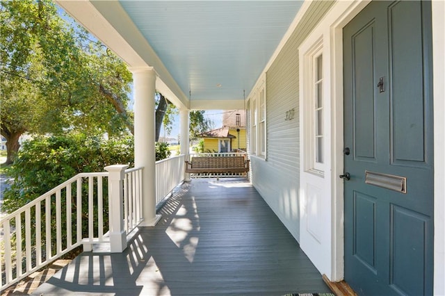 wooden terrace with a porch