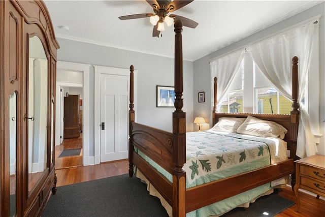 bedroom featuring ceiling fan, wood finished floors, and crown molding