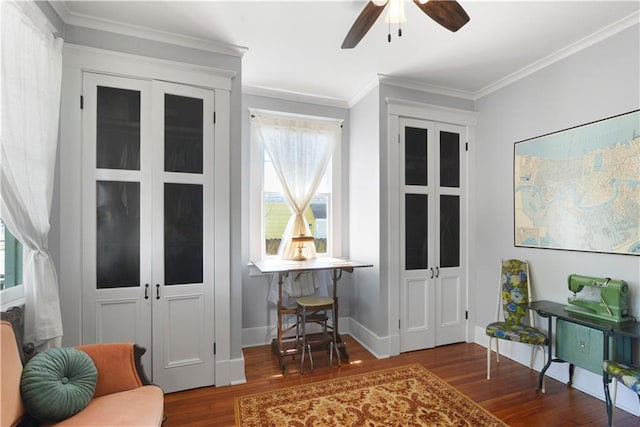 living area with a ceiling fan, baseboards, ornamental molding, and wood finished floors