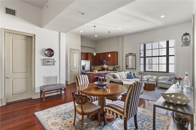 dining room with visible vents, dark wood-type flooring, and recessed lighting