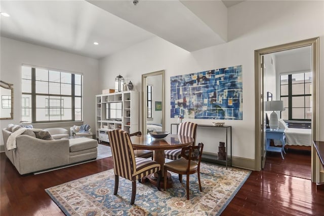 dining room with baseboards, hardwood / wood-style floors, and recessed lighting