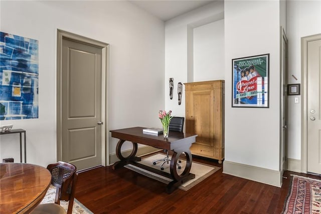 office area with dark wood-style floors and baseboards