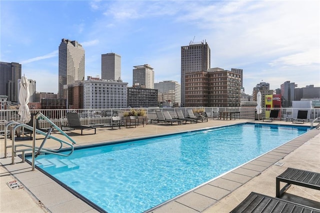 pool featuring a city view and a patio